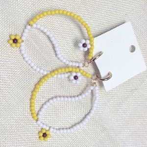 FREE PEOPLE Among the wildflowers Yin and Yang yellow white hoop earrings